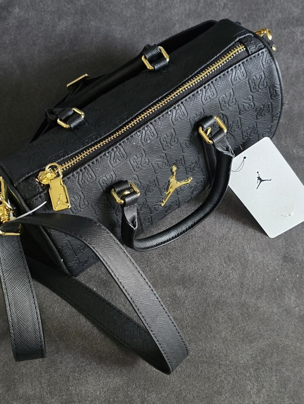A black Jordan Monogram Mini Duffle Bag With Jump Man On It - Picture 9 of 10